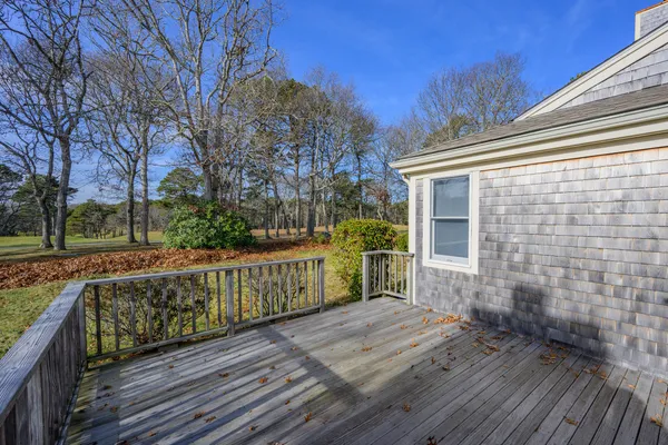 a view of a deck with wooden floor and fence