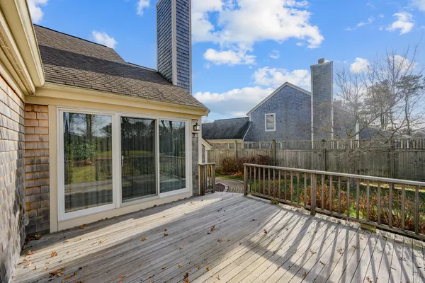a view of a house with a wooden deck