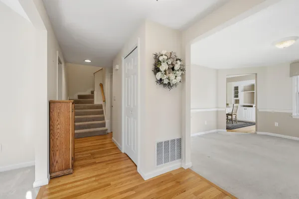 a view of a hallway with wooden floor and staircase