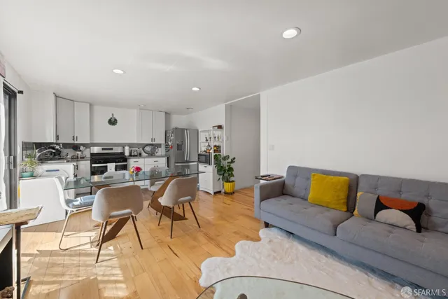 a living room with furniture and kitchen view
