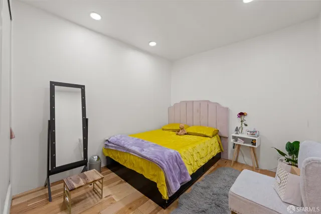 a bedroom with a bed and a couch