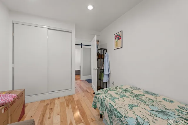 a bedroom with a bed and hallway