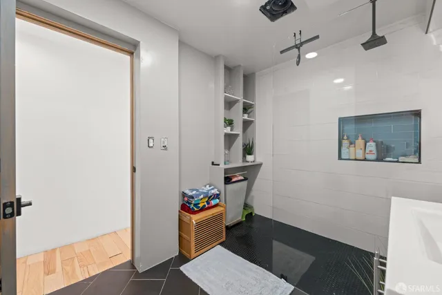 a hallway with a table and a potted plant