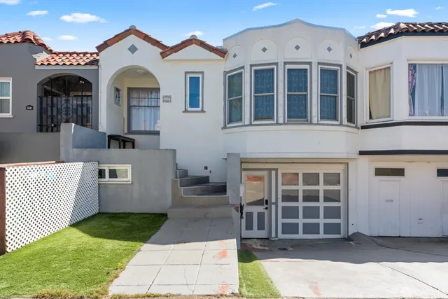a view of a brick house with many windows