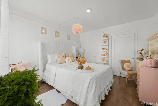 a bedroom with bed and a chandelier