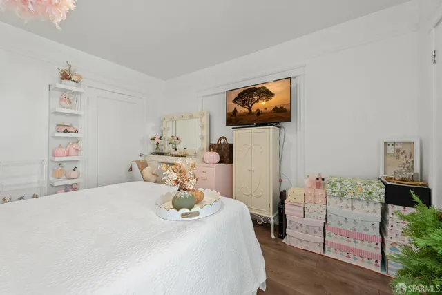 a bedroom with a bed and a a white wall