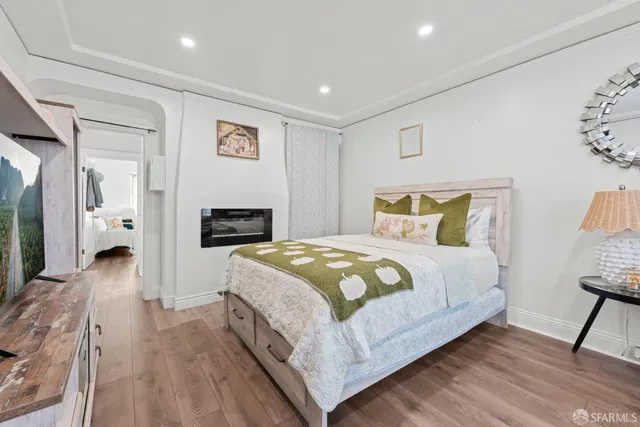 a bedroom with a bed and a flat screen tv