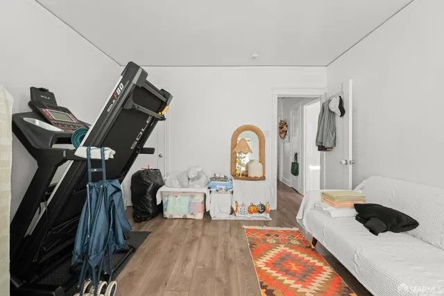 a bedroom with a bed a mirror and dresser