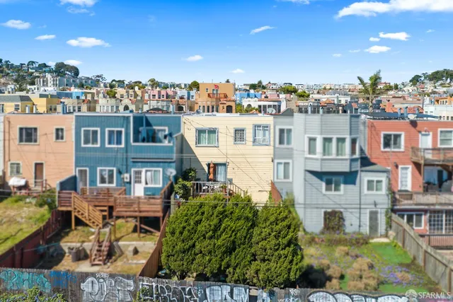 an aerial view of a house with a yard and potted plants