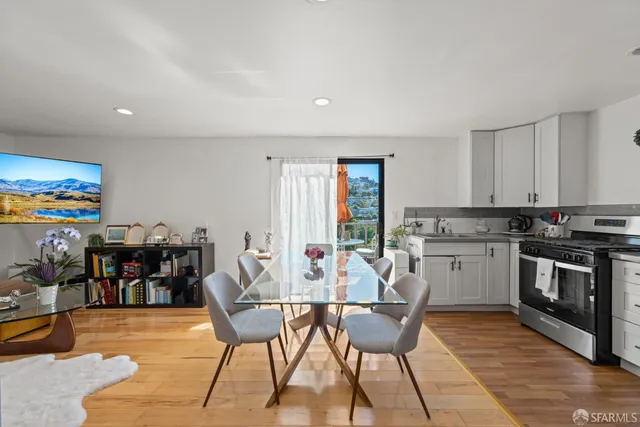 a view of a dining room with furniture and chandelier