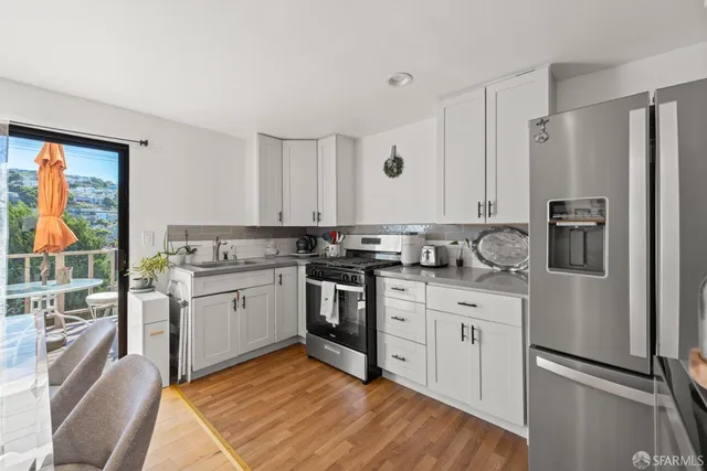 a kitchen with a refrigerator stove and sink