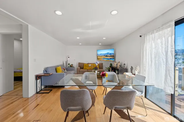 a living room with fireplace furniture and a wooden floor