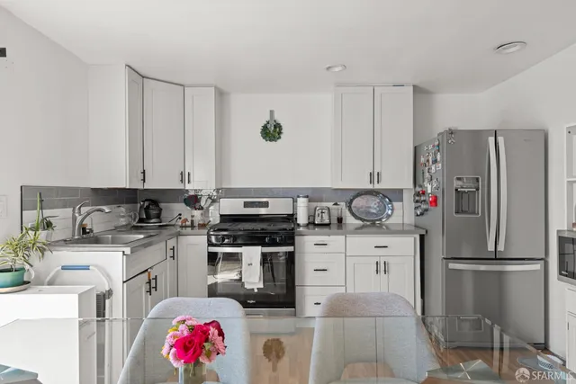 a kitchen with a sink stove and refrigerator