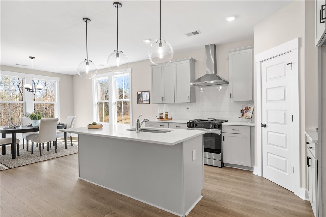 3401 Split Oak Circle Seneca, SC 29678 - Photo 5 of 8 This bright kitchen features a functional island and an inviting dining area with expansive views.