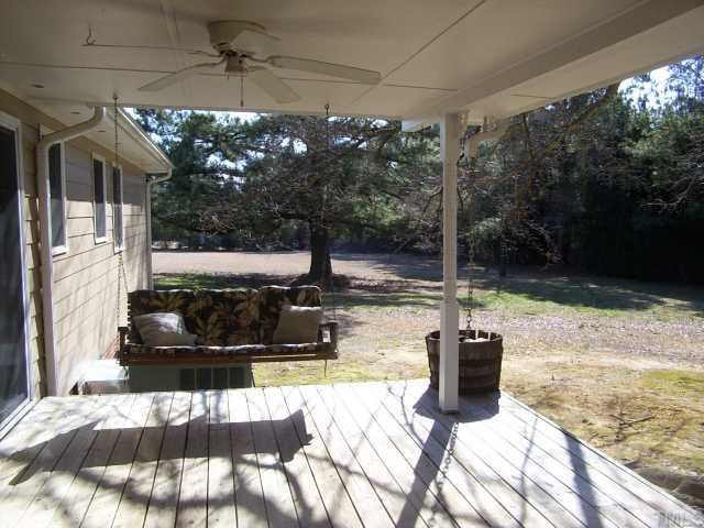 201 Cooper Branch Road Clayton, NC 27520 - Photo 3 of 12 Covered rear porch with ceiling fans and swing. You need to be here when it rains, it has a uniqued downspout setup.