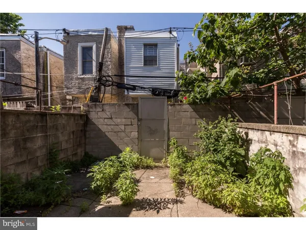 a backyard of a house with a yard and outdoor seating