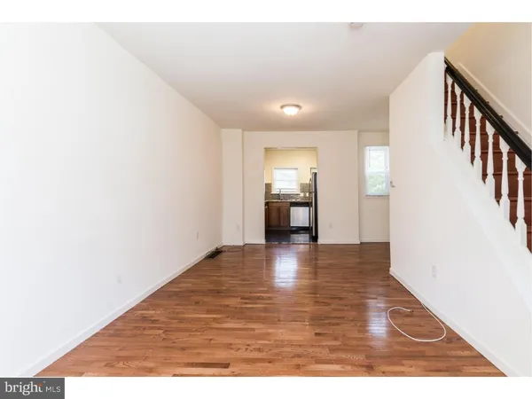 a view of an empty room and wooden floor