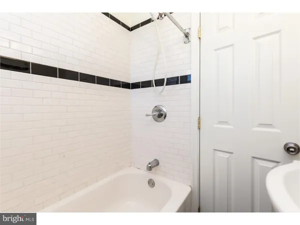 a bathroom with a bathtub and shower