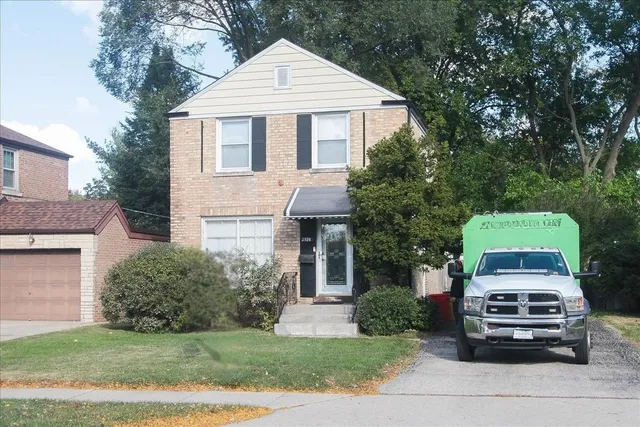 a car parked in front of white house