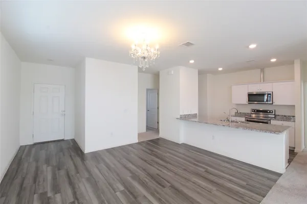 a view of kitchen with sink microwave and refrigerator