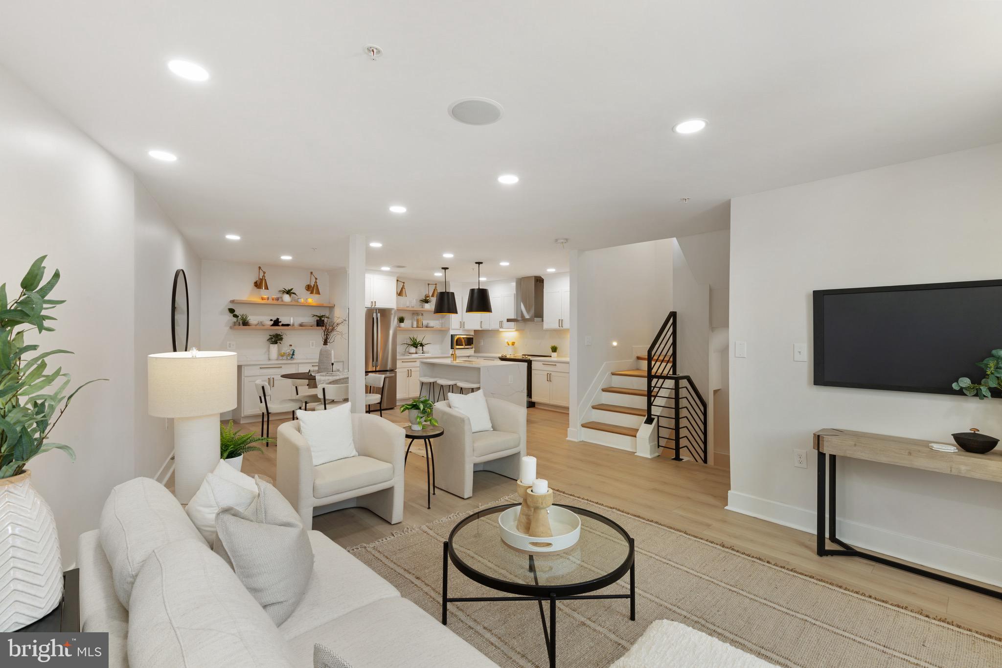 1601 Portugal Street Baltimore, MD 21231 - Photo 13 of 45 a living room with furniture kitchen view and a flat screen tv
