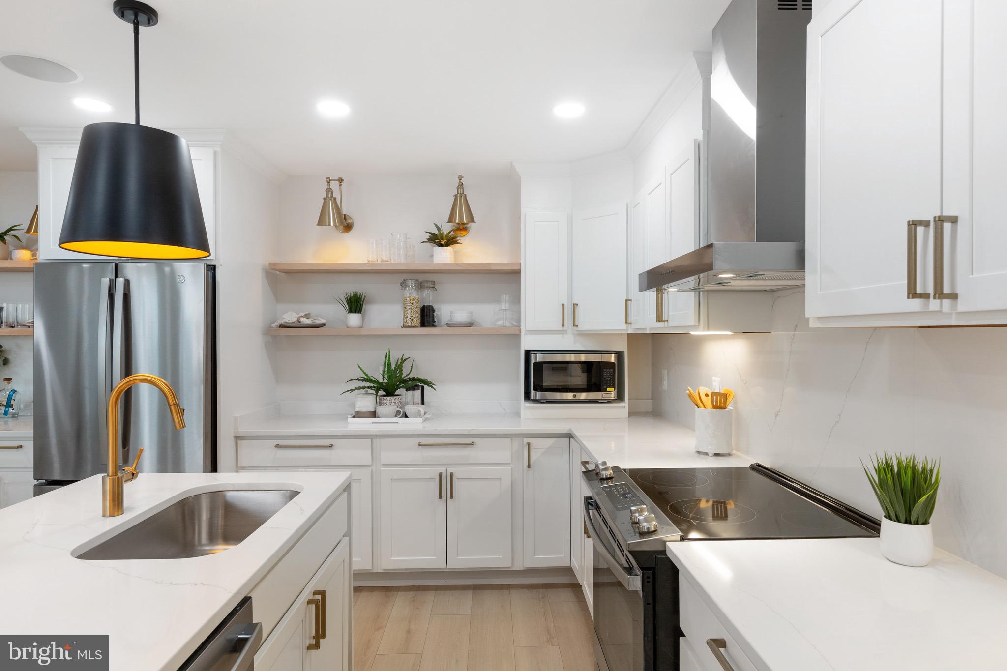 1601 Portugal Street Baltimore, MD 21231 - Photo 18 of 45 a kitchen that has a sink a stove and cabinets