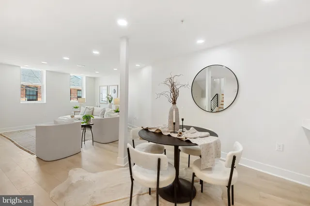 a living room with furniture a mirror and a table