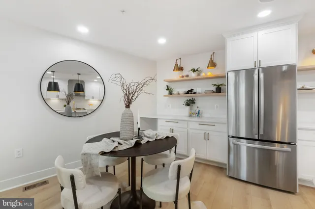 a kitchen with kitchen island a table and chairs