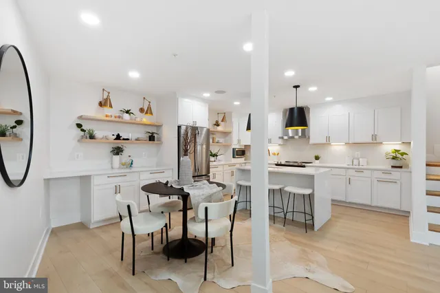 a kitchen with white cabinets and stainless steel appliances