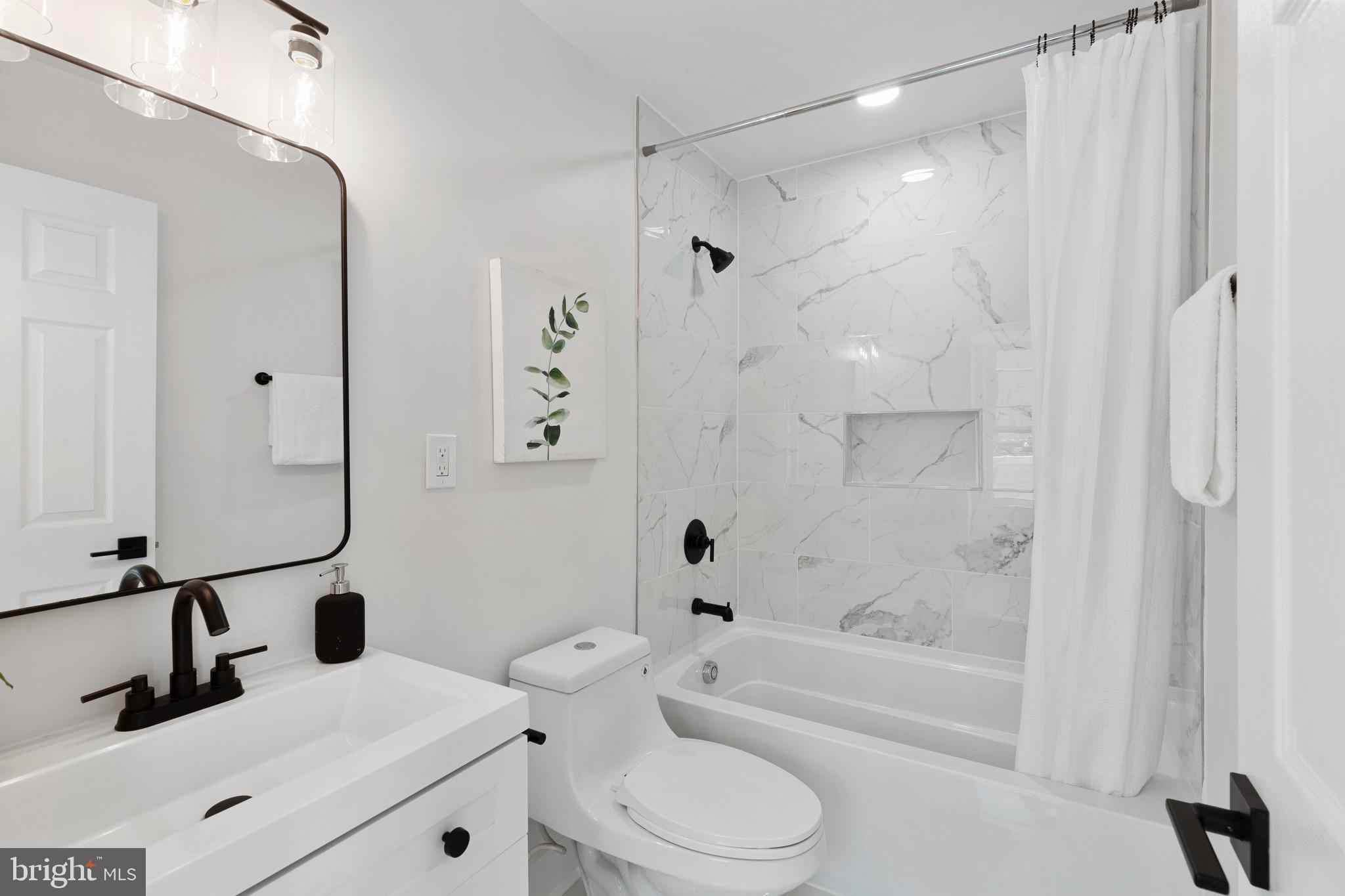 1601 Portugal Street Baltimore, MD 21231 - Photo 24 of 45 a bathroom with a bathtub shower sink vanity and toilet