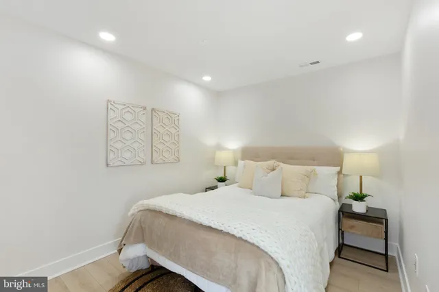 a bedroom with a bed and a lamp