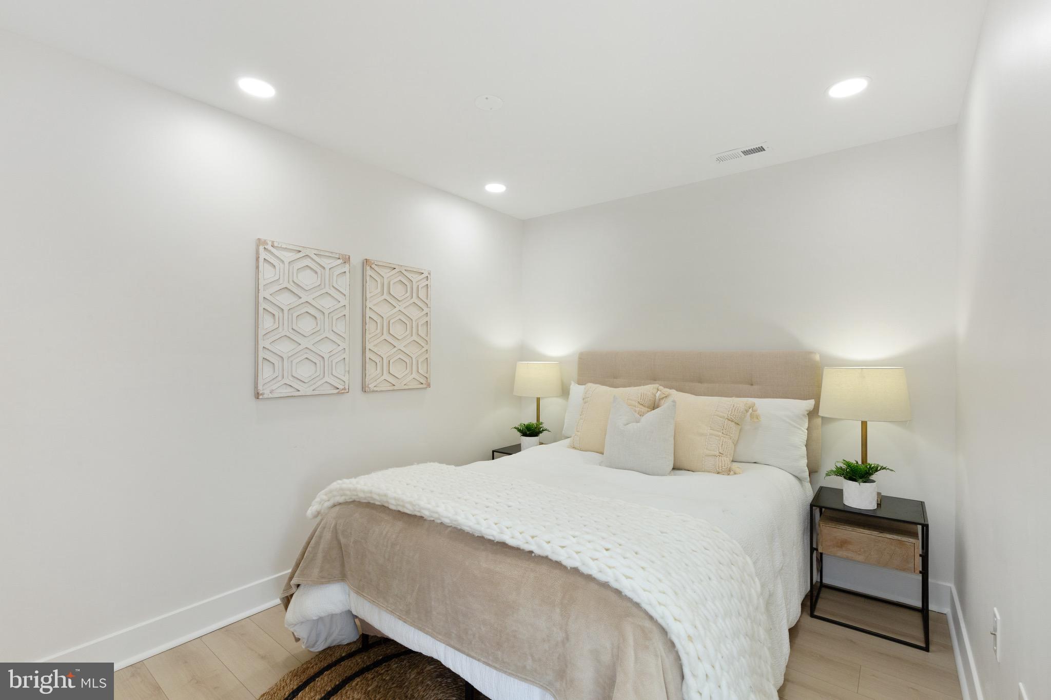 1601 Portugal Street Baltimore, MD 21231 - Photo 25 of 45 a bedroom with a bed and a lamp