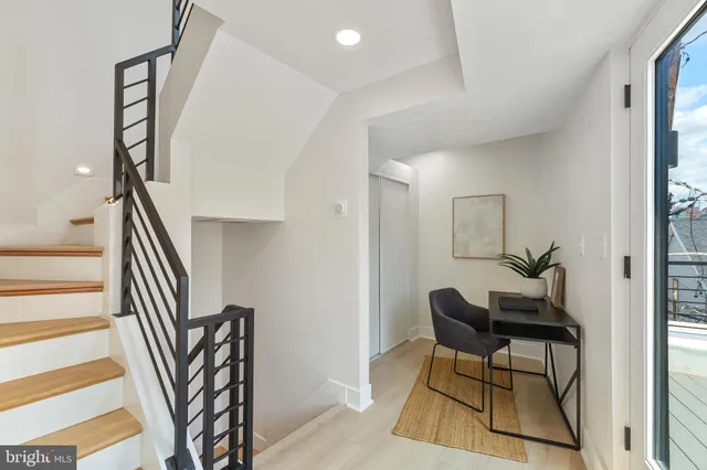a view of a livingroom with furniture and stairs