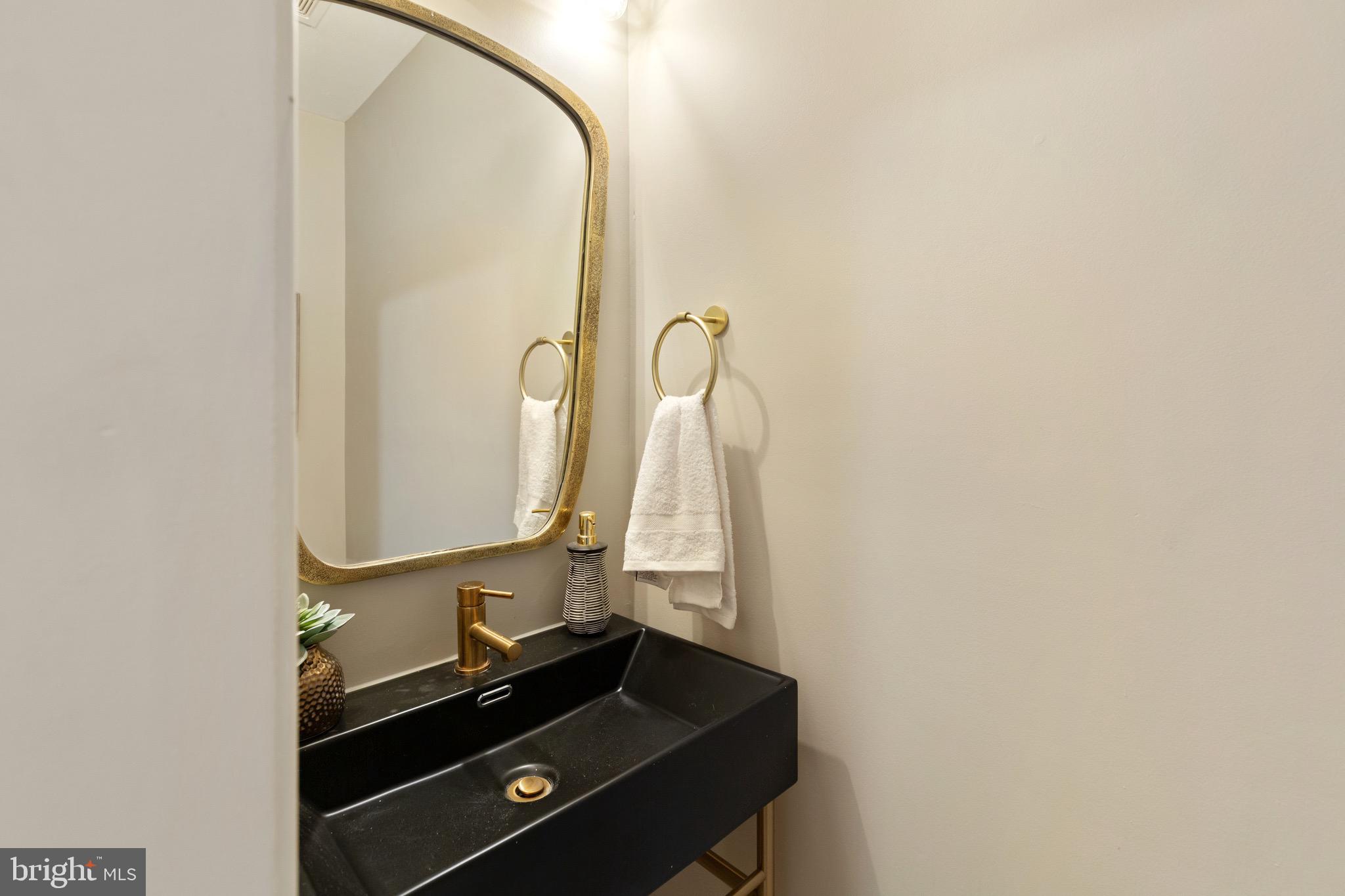 1601 Portugal Street Baltimore, MD 21231 - Photo 36 of 45 a bathroom with a mirror and a sink