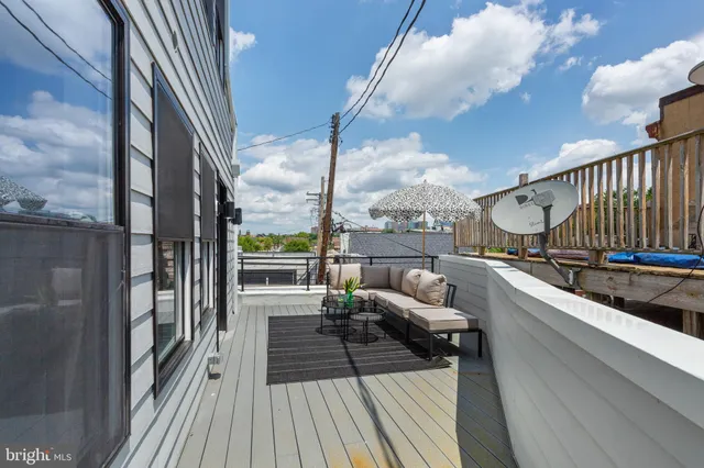 a balcony with furniture and a potted plant