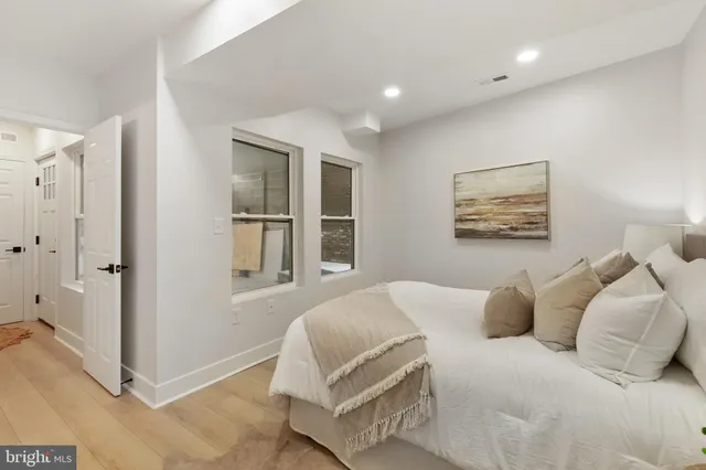 a bedroom with a large bed and a window