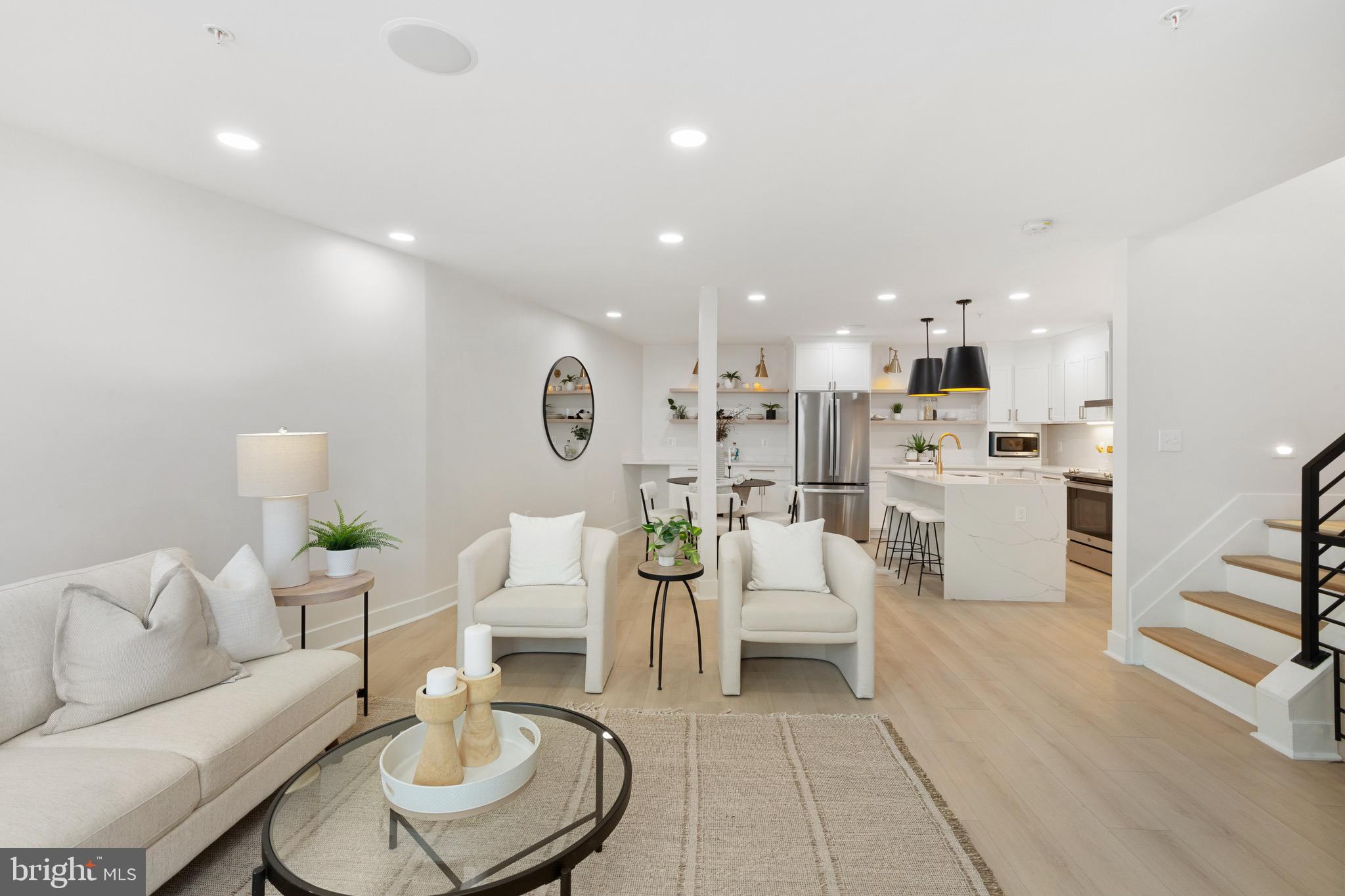 1601 Portugal Street Baltimore, MD 21231 - Photo 10 of 45 a living room with furniture and a dining table with kitchen view