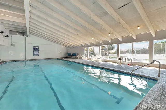 a room with a wooden floor and a large window