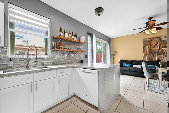 a kitchen with a refrigerator and a stove top oven