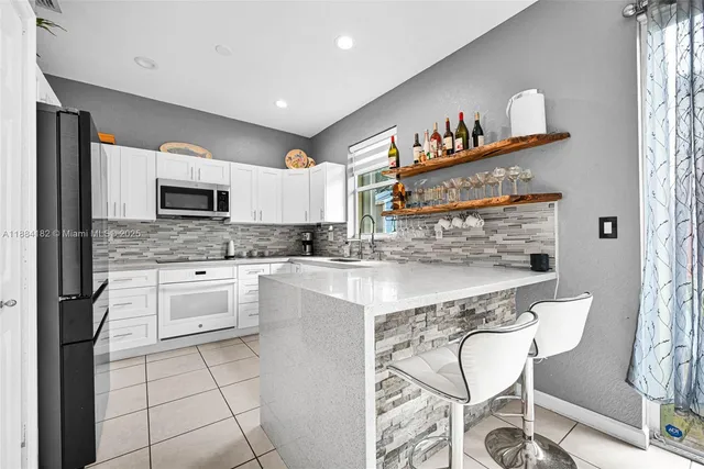 a kitchen with a refrigerator and a stove