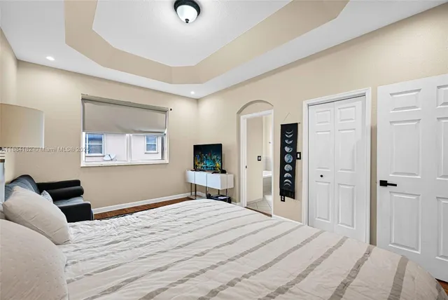 a bathroom with a bathtub sink vanity mirror and toilet