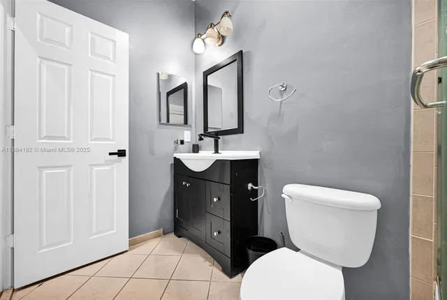 a bathroom with a sink a toilet and mirror