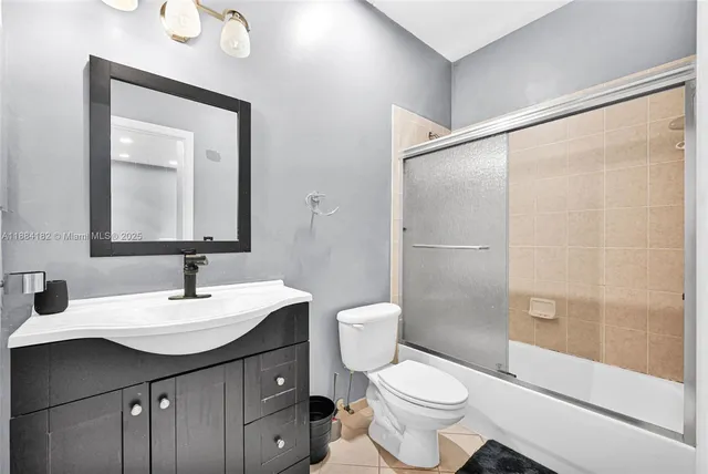 a backyard with table and chairs with wooden fence