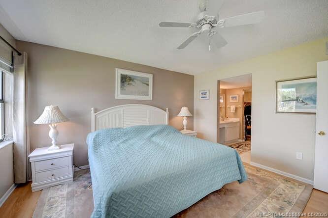 1950 Southwest Palm City Road, Unit 3209 Stuart, FL 34994 - Photo 21 of 64 Primary ensuite bedroom with water view.