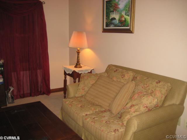 2240 Mill Road Henrico, VA 23231 - Photo 7 of 10 a bed sitting in a bedroom next to a wooden cabinet