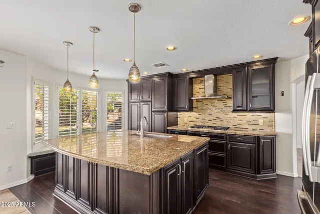 a kitchen with stainless steel appliances granite countertop stove top oven and refrigerator