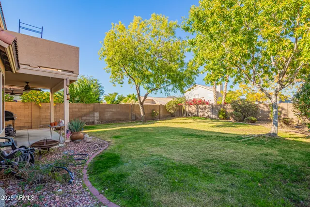 a view of yard with swimming pool and sitting area