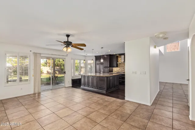 a large white kitchen with granite countertop a refrigerator and a stove top oven