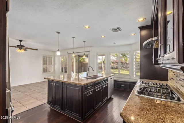 a kitchen with a stove and a wooden floors