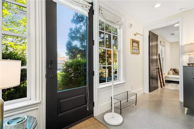 a view of a porch with furniture and front door